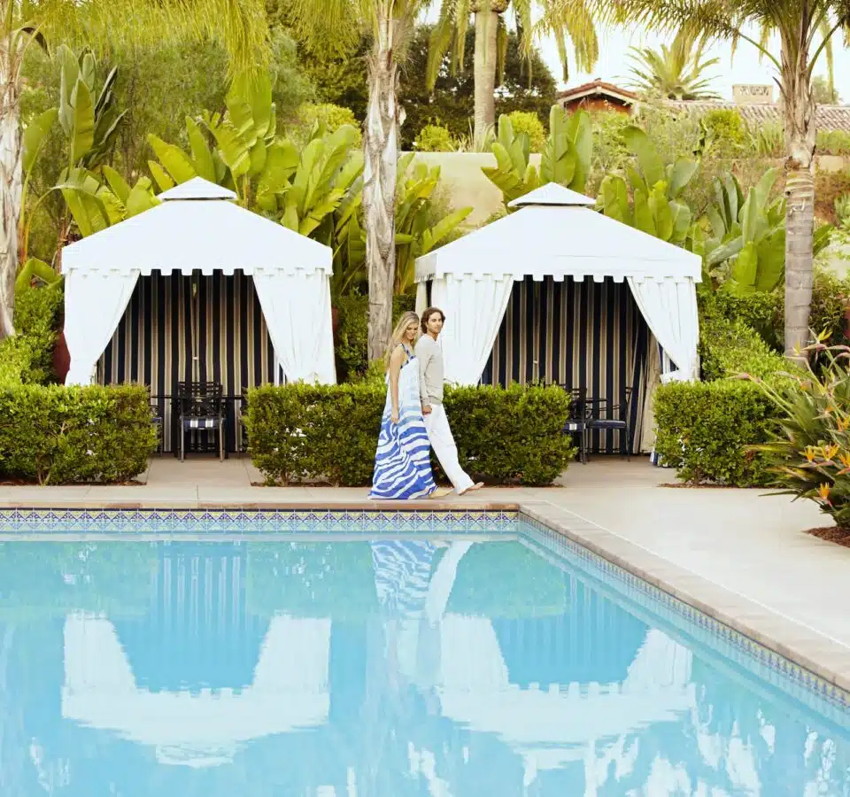 Caucasian couple walking at poolside