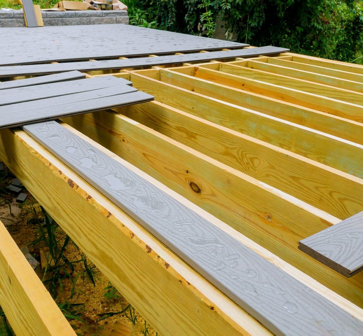 A new wooden, timber deck being constructed. it is on the decking. New deck patio