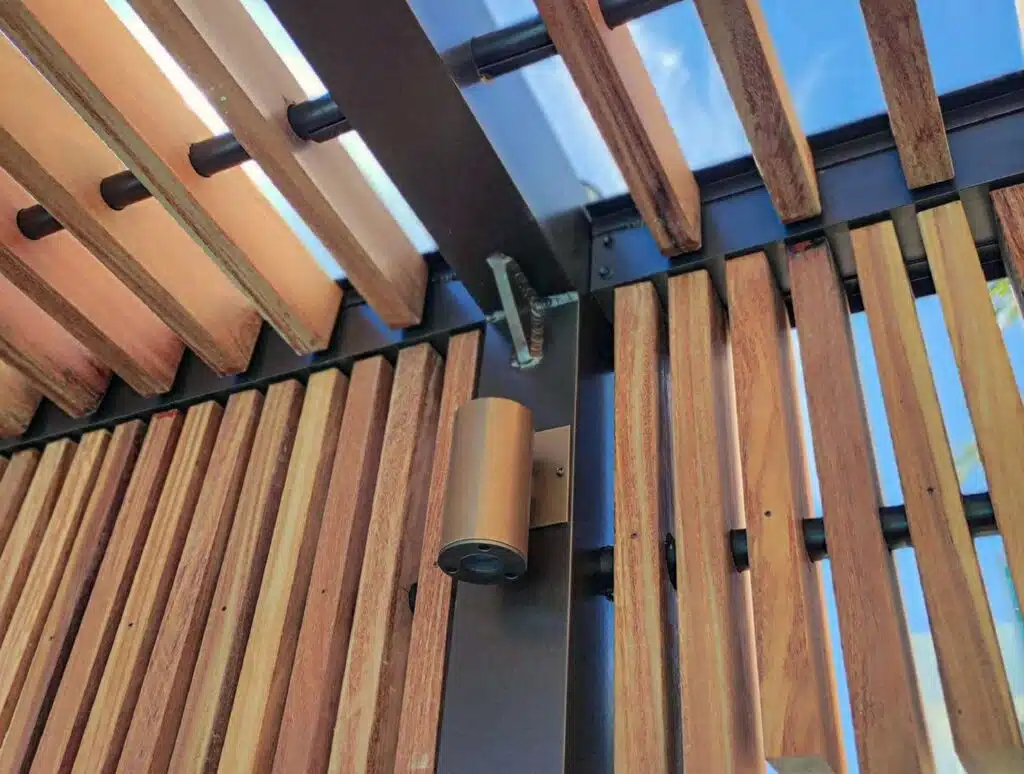 Detail of a Valrose aluminum pergola frame with hardwood slats and integrated lighting at the Diplomat Beach Resort